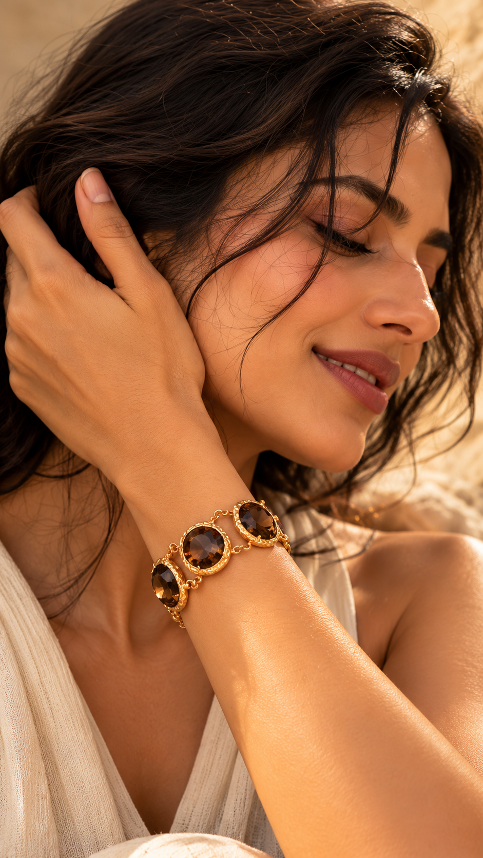 Herelina gold-toned statement bracelet with smoky-brown stones from Medoso Jewellery’s Desert Heirloom collection, styled on a model in warm natural light.